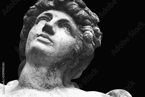 Black and white close-up of a stone statue of Aphrodite, symbolizing beauty, love, grace, and ancient Greek mythology.