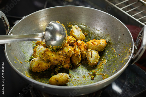 Indian style taro root curry being cooked in a wok