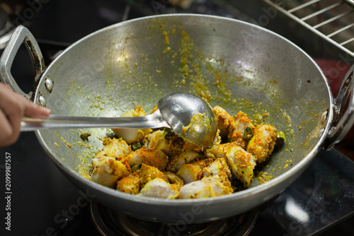 Indian style taro root curry being cooked in a wok