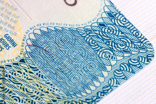 Obraz na płótnie An extreme close-up view of an Italian Schengen visa shows complex microprinting, wavy guilloche patterns, and holographic elements designed to prevent counterfeiting and secure international travel