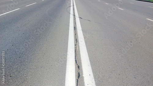 Canvastavla Highway with double white center lines, road surface detail, transportation and
