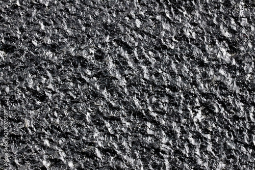 Black painted cast iron texture surface background macro close up rough metallic material dark backdrop pattern structure industrial solid gritty coarse textured sheet details uneven hard element
