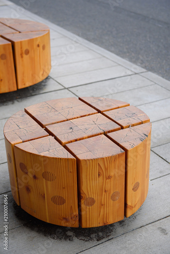 A cylindrical stool crafted from reclaimed pine wood blocks, adding rustic charm to a public space in Seattle.