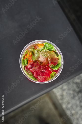 Homemade strawberry lemonade with fresh mint. Cold strawberry lemonade garnished with mint leaves and served over ice. Refreshing fruit drink for summer.