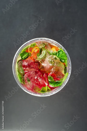 Top view of strawberry lemonade with mint. Fresh strawberry lemonade with ice cubes and mint leaves photographed from above. Summer beverage concept.