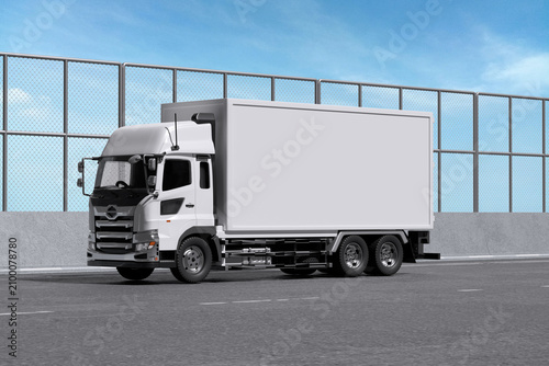 White box truck on the road with fence and sky background for mockup template