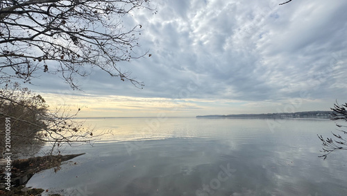 фотографія Quiet misty lake beneath layered gray clouds