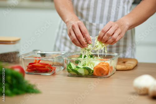 Woman hands preparing meal prep healthy vegetables