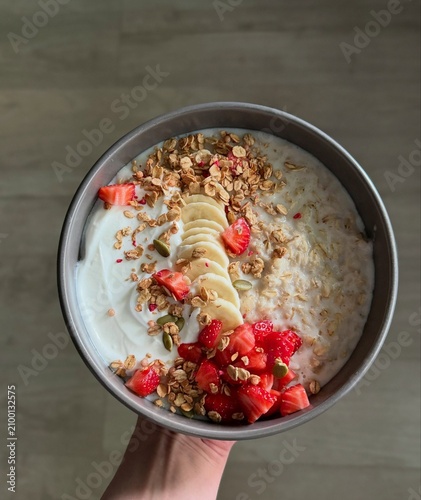 A nutritious bowl of creamy oatmeal topped with fresh berries and seeds. Perfect for healthy eating, breakfast, nutrition, fitness, lifestyle, organic food and wellness promotions.
