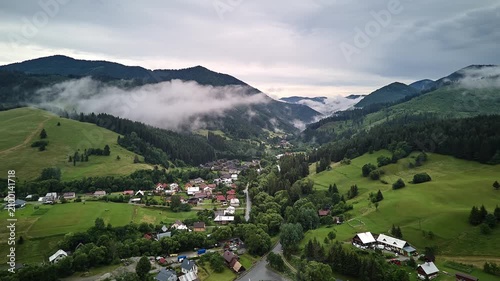 Aerial Hyperlapse Mountain Valley Village With Fog Drifting Over Slopes at Dawn