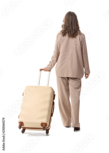 Woman in beige suit walking...