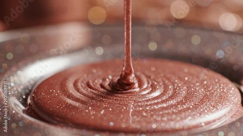 Glossy Melted Chocolate Pouring From Spoon Into Decorative Plate With Bokeh Background Highlighting Rich Texture And Shimmering Details