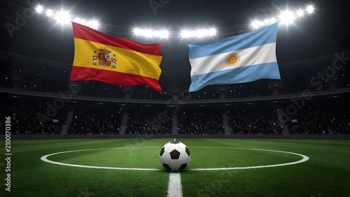 Spain and argentina flags waving in a dark stadium with a soccer ball on the pitch
