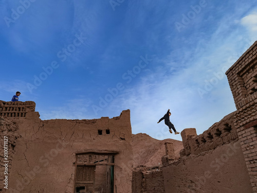 Obraz na płótnie Active boy practicing parkour in historic Kashgar old town, Xinjiang, China