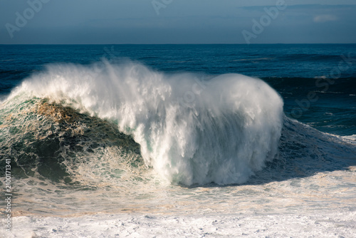 Canvas Print Giant big wave surfing in Nazare, Portugal, with massive ocean swell and extreme