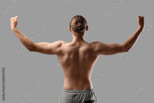 Konstfotografi Sporty muscular man on grey background, back view