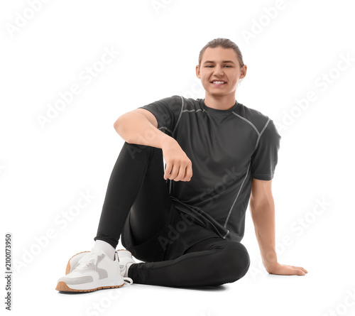 Sporty young man sitting on...