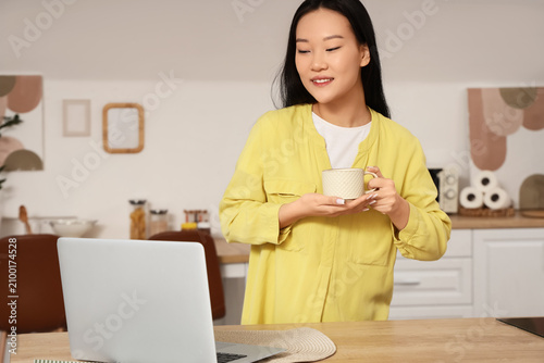 Young Asian woman drinking ...