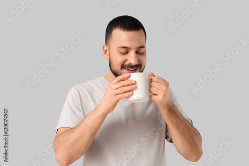 Handsome young man drinking...