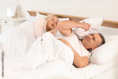 Irritated mature man lying ...