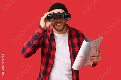 Young male tourist with map...