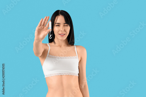 Young woman with tampon on ...