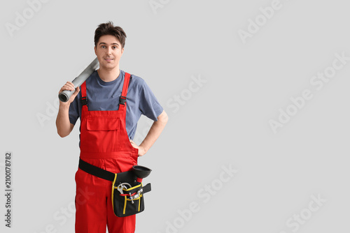 Male plumber with pipe and ...