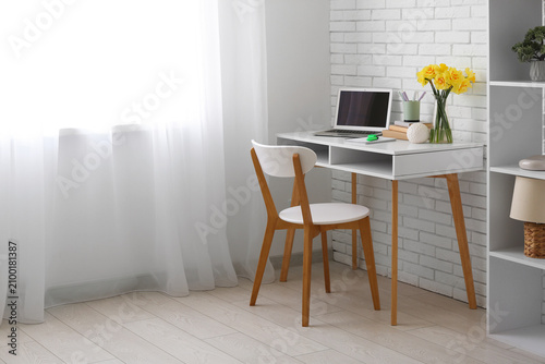Workplace with bouquet of n...