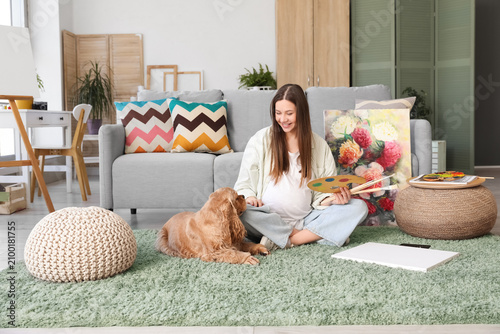 Pregnant artist sitting on ...