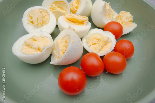 Boiled Eggs and Cherry Tomatoes on a Green Plate