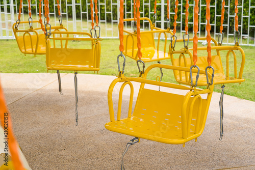 Εκτύπωση καμβά Swing Carousel Amusement Ride: Empty yellow seats of a swing carousel ride hang motionless, inviting the viewer to imagine the thrill and fun of a fairground