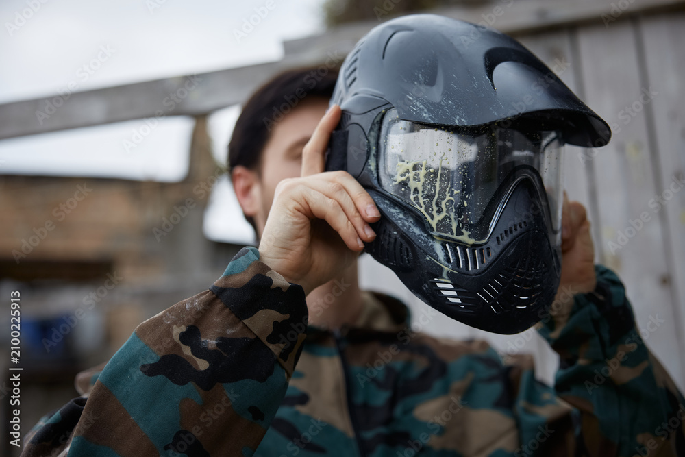 Fototapeta premium A man soldier is wearing his defensive helmet at the battlefield