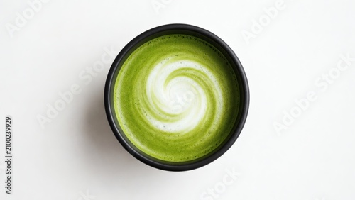 A single plain matte black ceramic mug with green matcha latte art on a white background