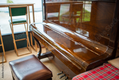 Valokuva Elegant Wooden Piano with Bench and Decor