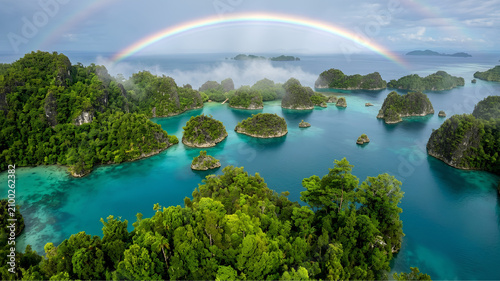 A breathtaking aerial drone photograph of the Piaynemo archipelago in Raja Ampat immediately after a tropical rain shower