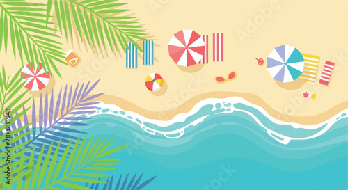 Top view of a tropical beach with umbrellas, towels, and waves.