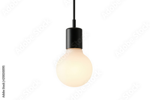 Modern hanging light bulb glowing with warm soft light in dark metal.
