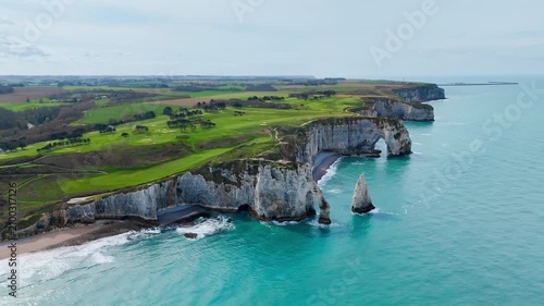 Panoramic drone view of Etretat cliffs on French coast in Normandy. Chalk coastline and rock formations above sea