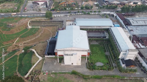 Aerial Drone Pan Over Industrial Buildings and Rural Farmland in Tropical Landscape