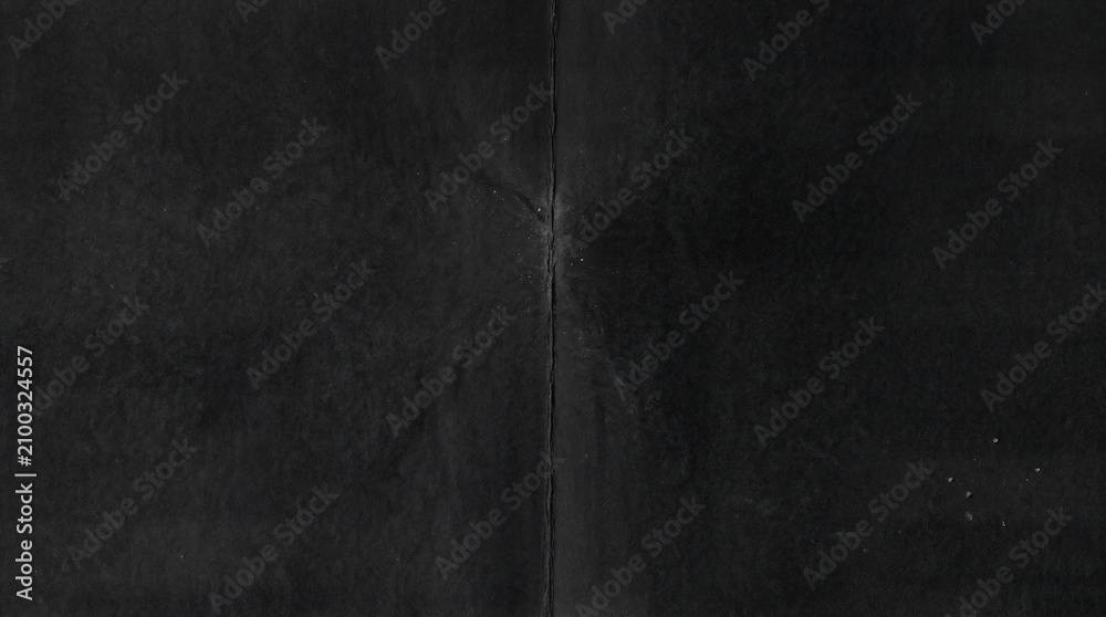 Fototapeta premium Gritty Folded Paper Texture Overlay. Distressed Creased Black Paper Background. Grunge Analog Scan Surface, Film Texture