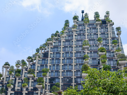 Фотография 1000 trees building with planters on pillars creates vertical garden facade