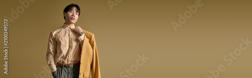 Konstfotografi Young man with fashionable flair poses confidently, exuding charm and elegance in trendy outfit