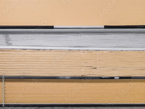 Obraz na płótnie Stacked books with contrasting yellow and grey page edges