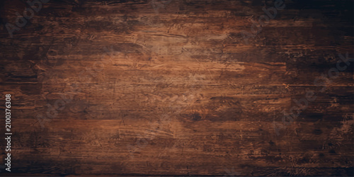 A detailed close-up captures the rich texture and grain of a dark, rustic wooden surface, showcasing its natural imperfections and warm, earthy tones.