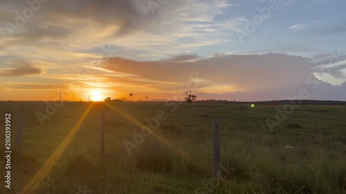 Golden Sunset Over Rural Landscape Seen from a Moving Vehicle in Brazil