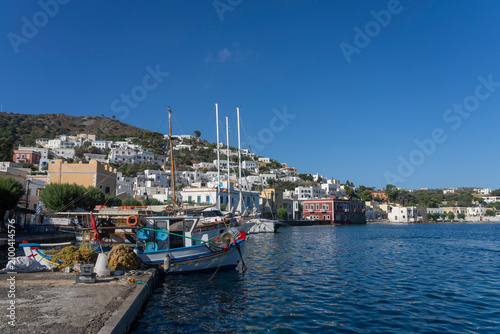 Fishing boats docked at Agia Marina harbor with colorful buildings on Leros Island in Dodecanese region of Greece