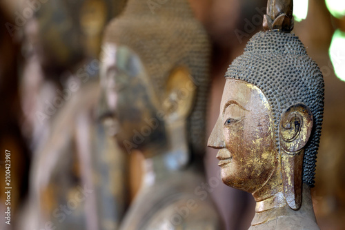 Buddha statue in calling for rain position at Wat Visounnarath temple from the 17th to 18th century in Luang Prabang, Laos