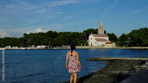 Woman Looking Across Coastal Church