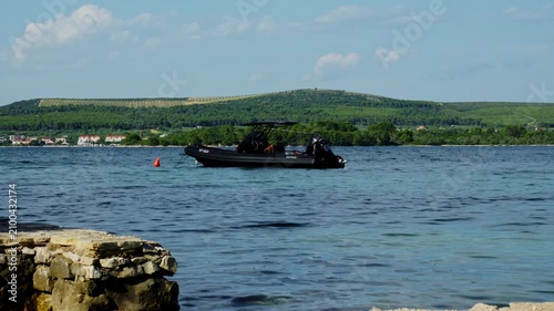 Black Motorboat Floating On Blue Sea