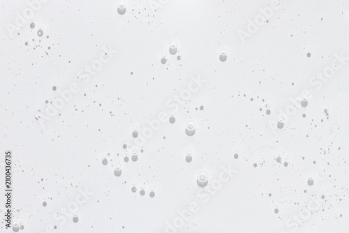 Close up of transparent gel texture with small bubbles. Abstract glossy liquid material suitable for cosmetic, skincare and scientific concepts.